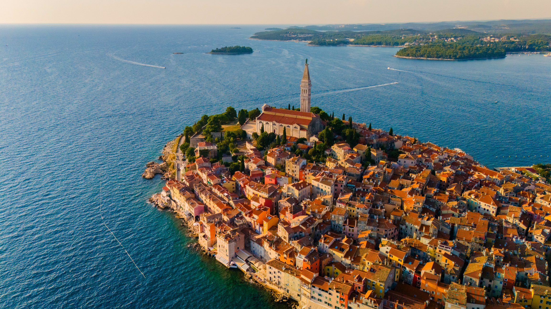 Aerial view of Rovinj Old Town glowing in golden hour light